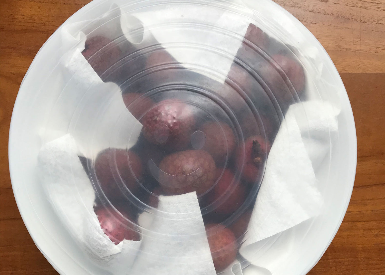 Lychee in bowl with plastic covering for storage, after delivery to US mainland.